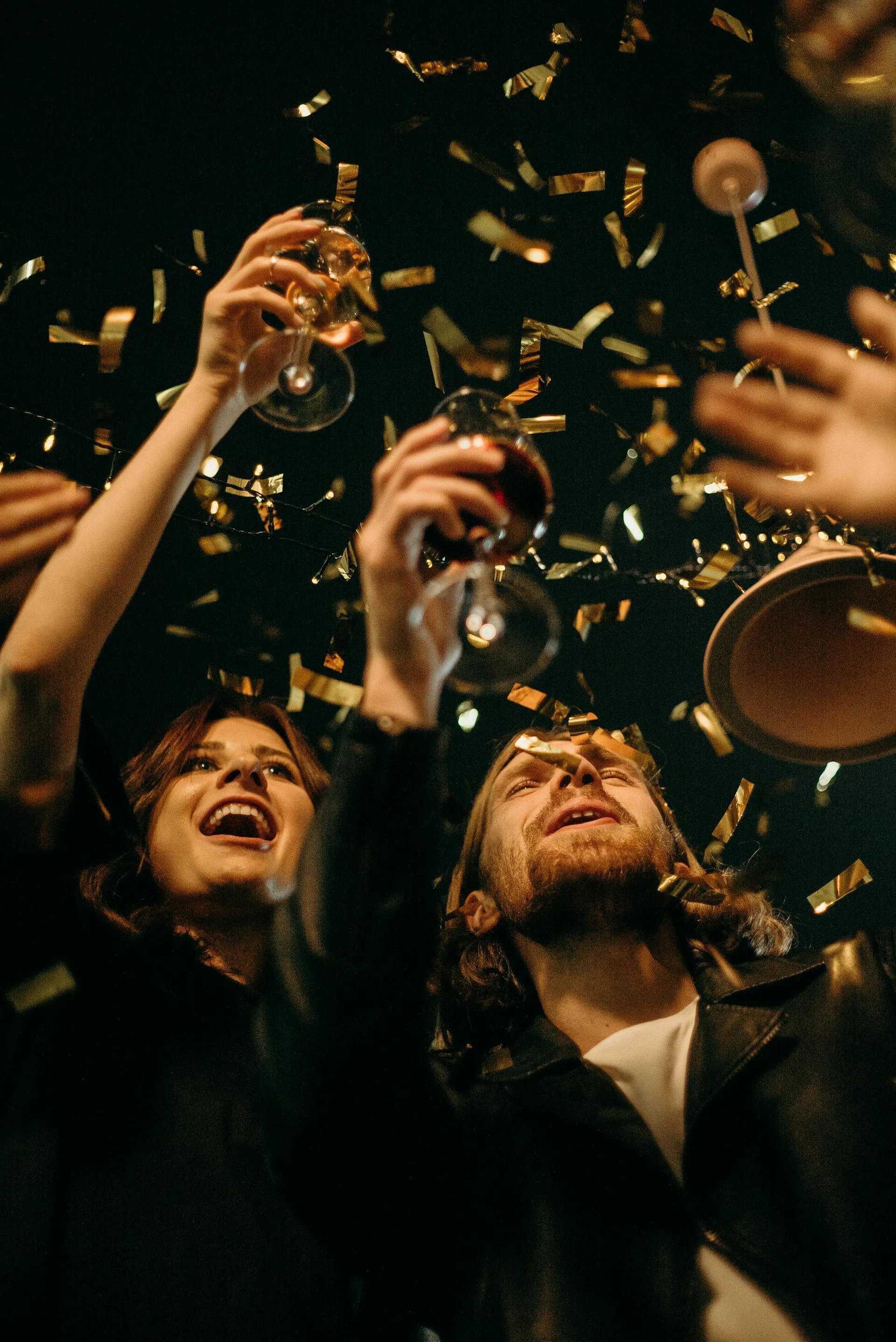 Friends toasting with wine glasses at an event